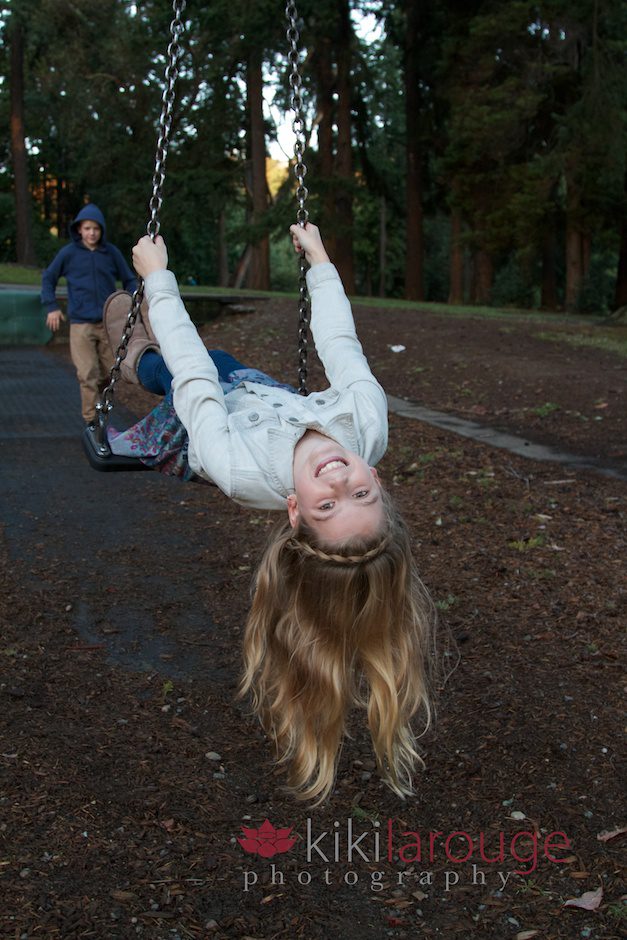 Girl upside down on swing