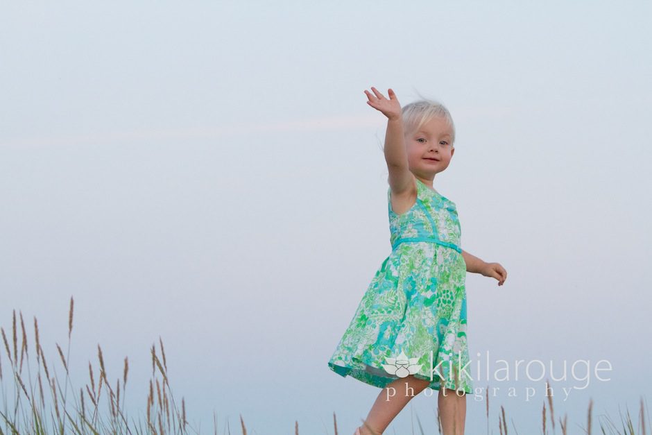 Toddler waving from boardwalk