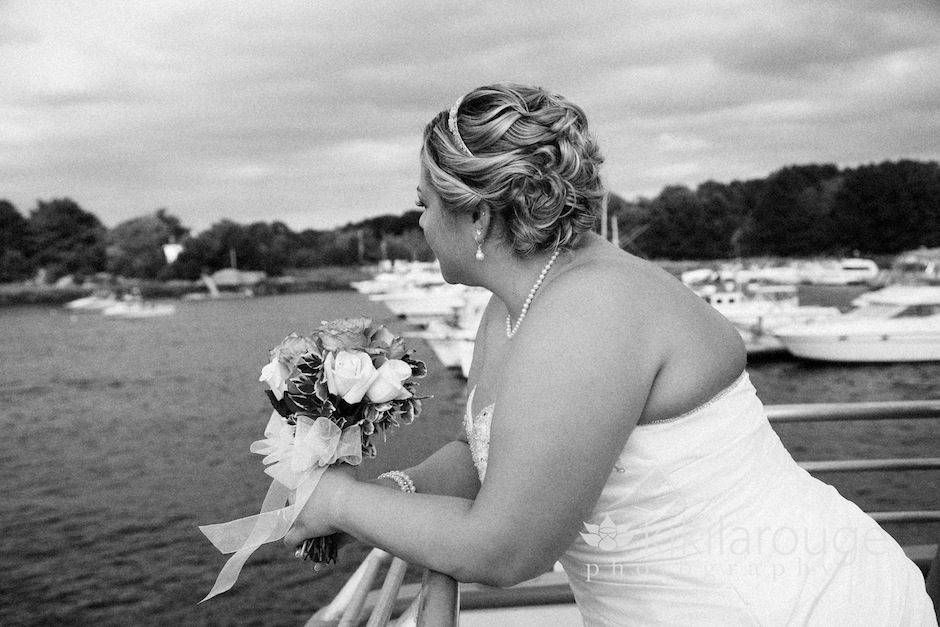 Bride looking out on water