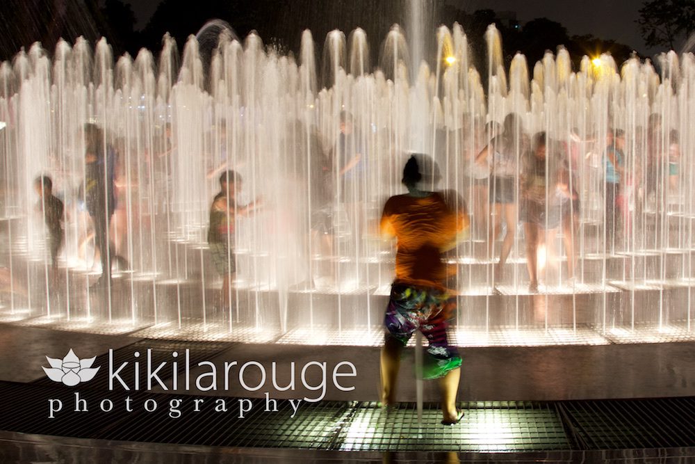 Kids playing in water fountain