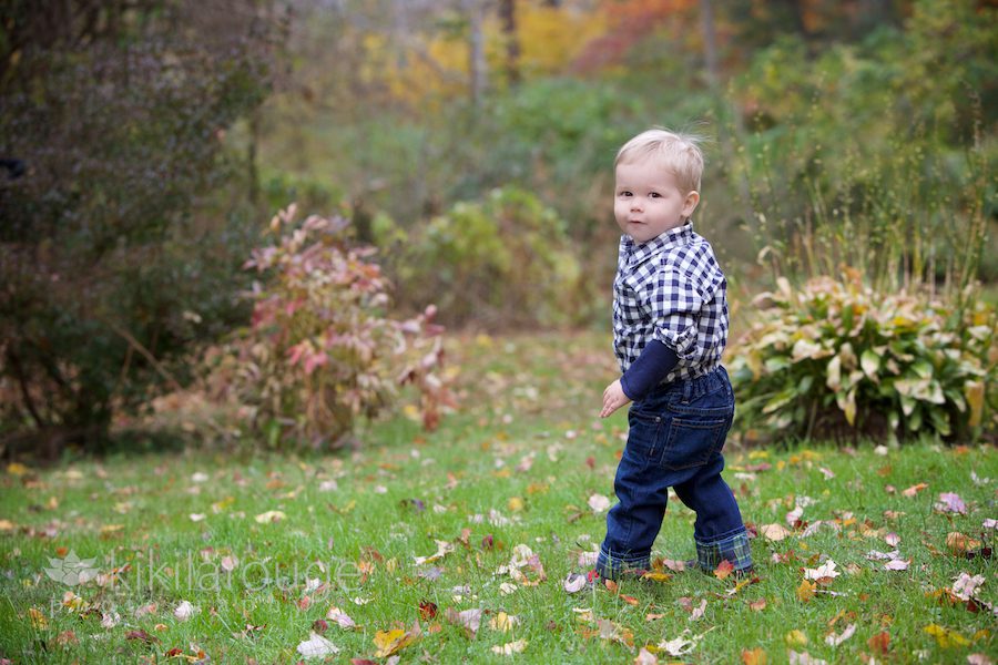 Little boy playing in the leaves