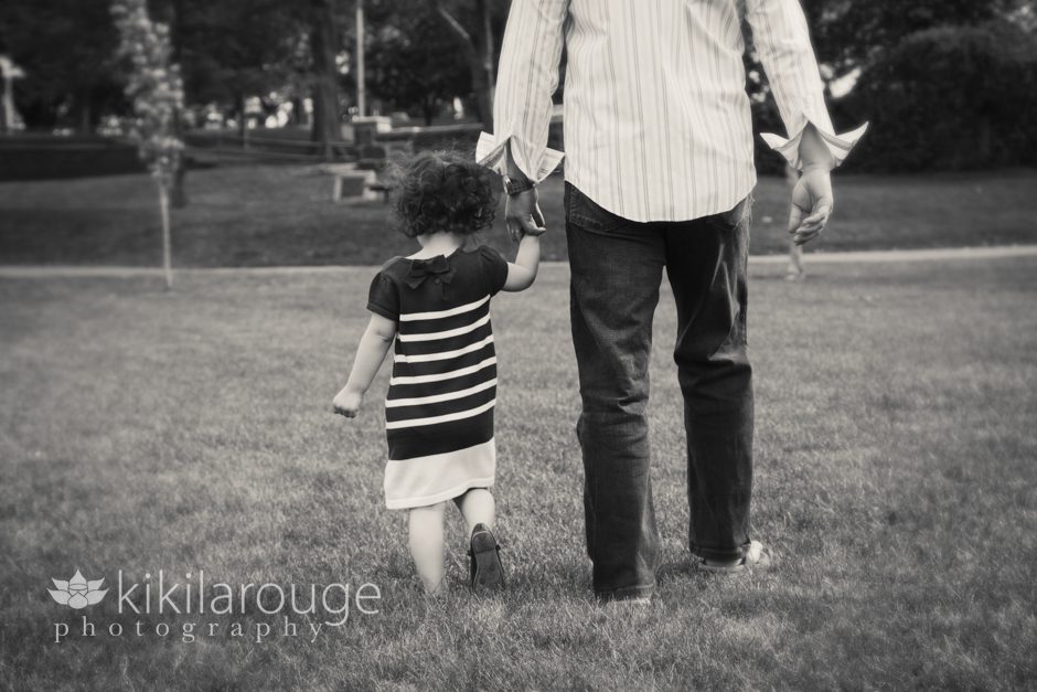 Little girl and Dad walking at park