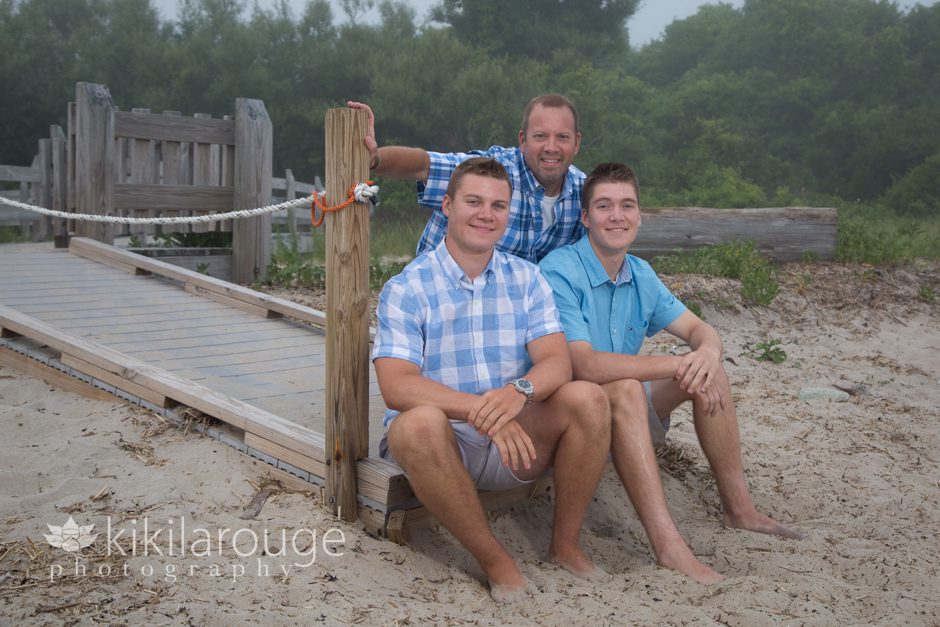 Dad with his teenage boys at beach