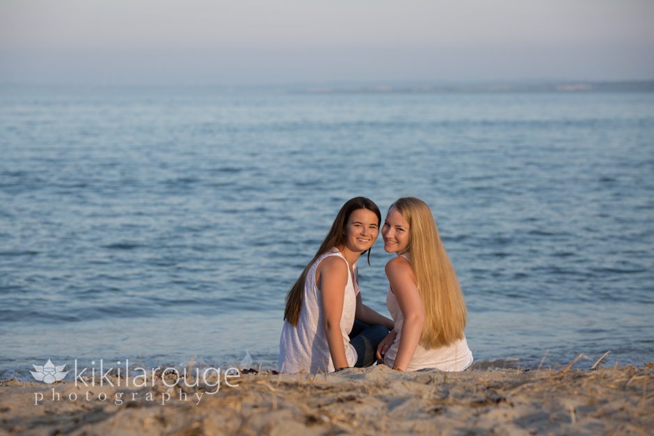 Sisters sitting by the ocean