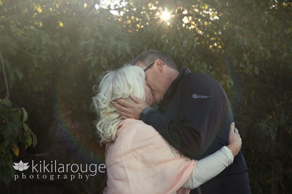 Couple kissing with sun flare