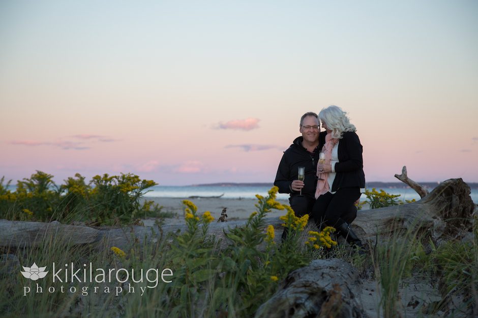 Engaged Couple on Driftwood at Sunset
