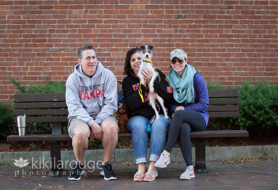 Newly Adopted dog with family on bench