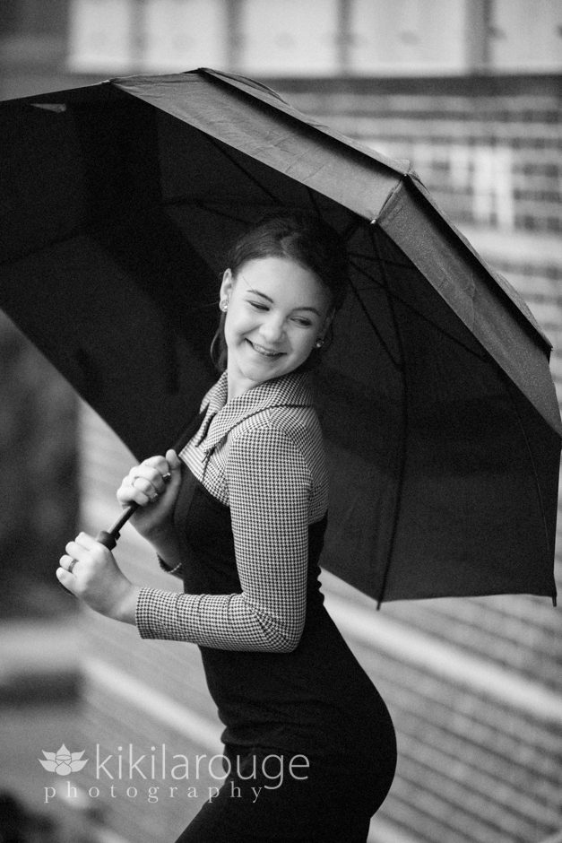 Girl in dress with umbrella in rain
