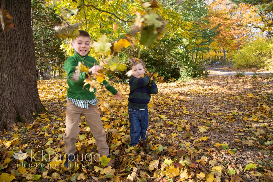Boys playing in fall yellow leaves