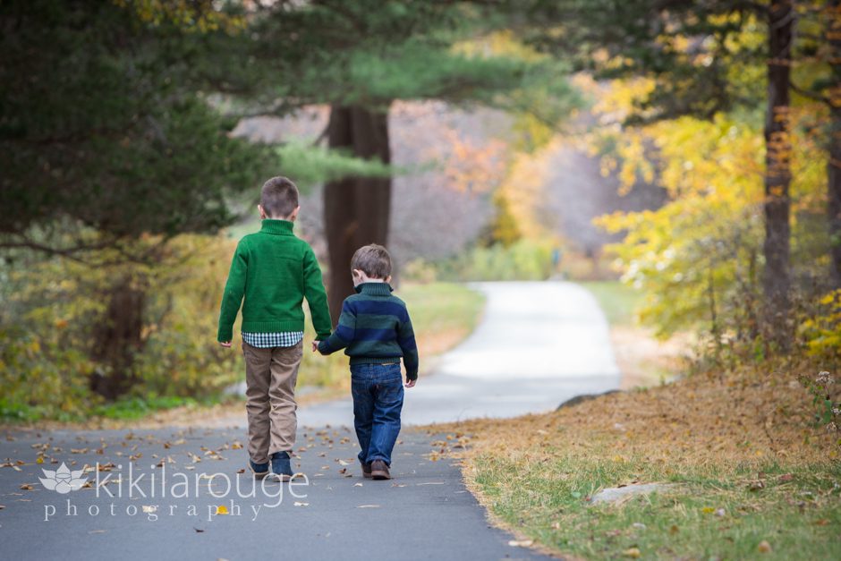 Brothers walking down fall road