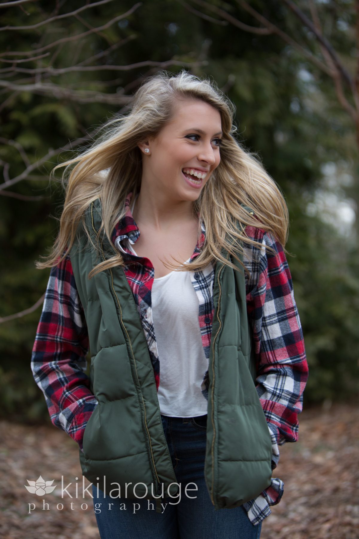 Senior portrait girl laughing in woods
