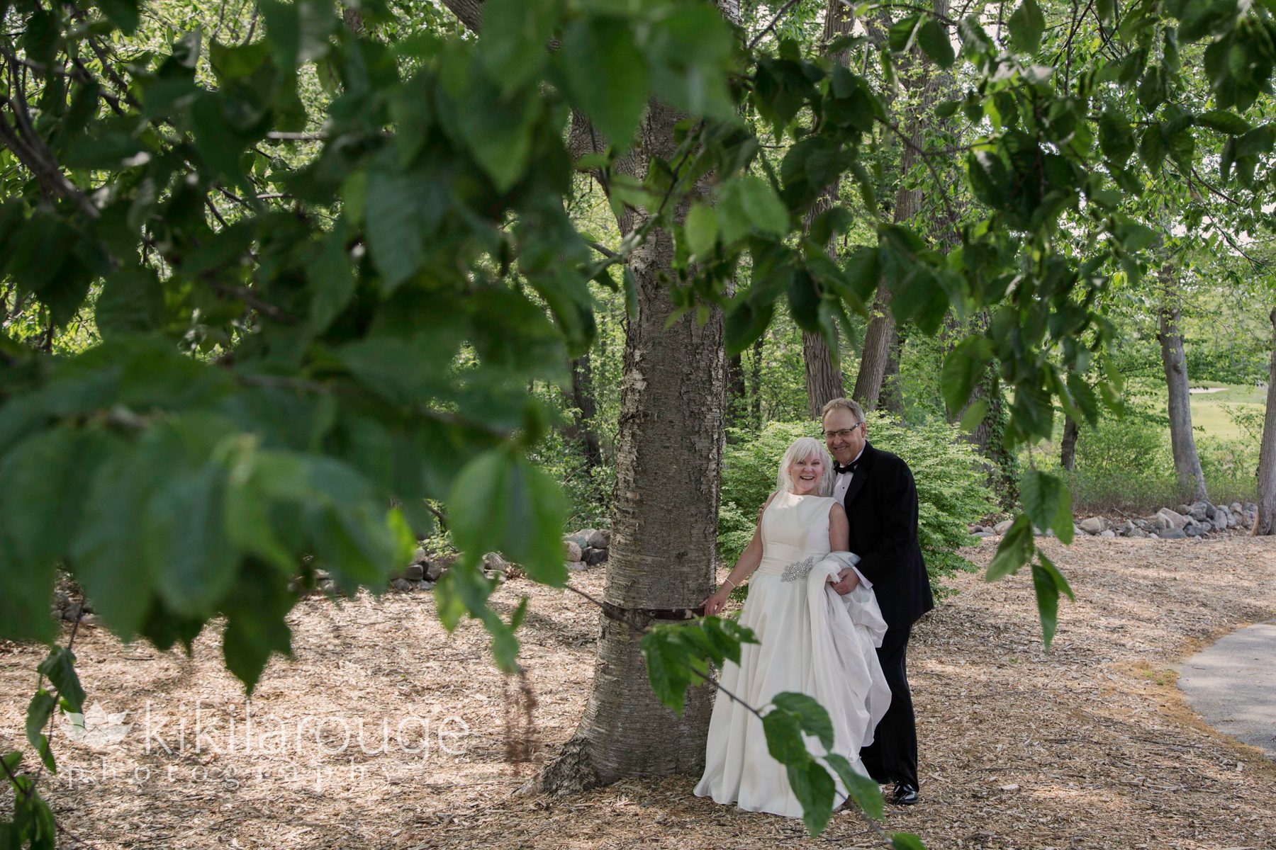 Wedding couple woods surrounded by greenery
