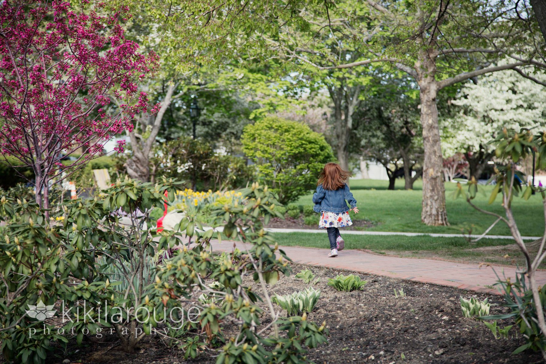 Little girl running through garden