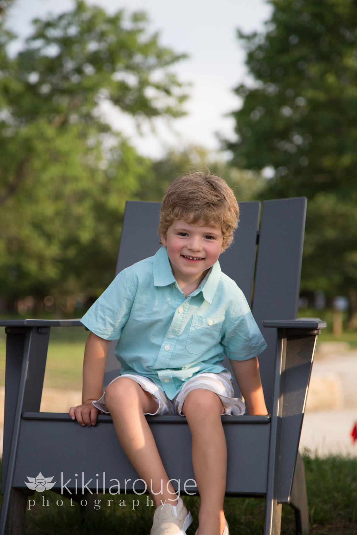 Smiling toddler in an adirondack chair