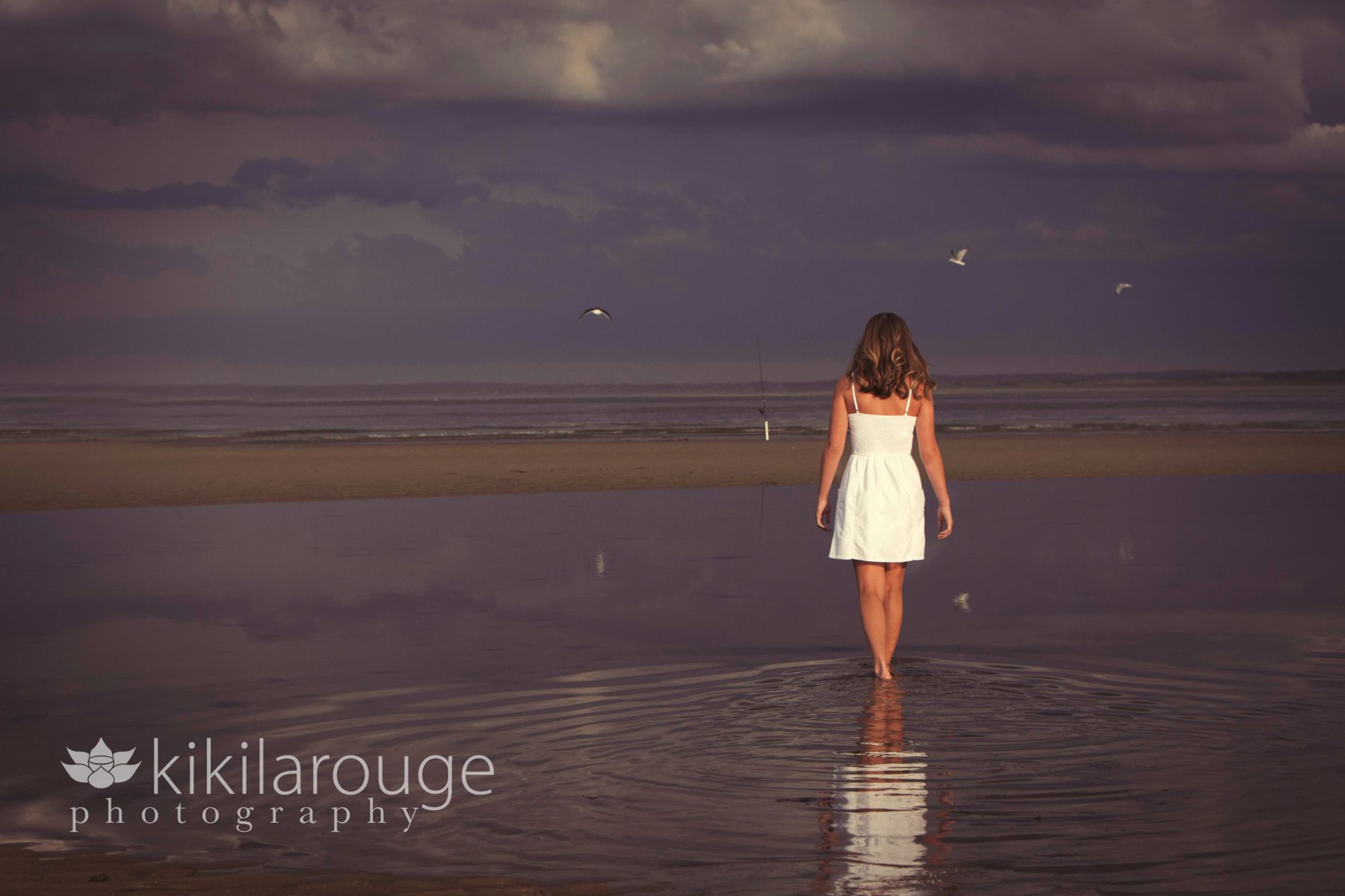 Girl walking through tide pool at beach