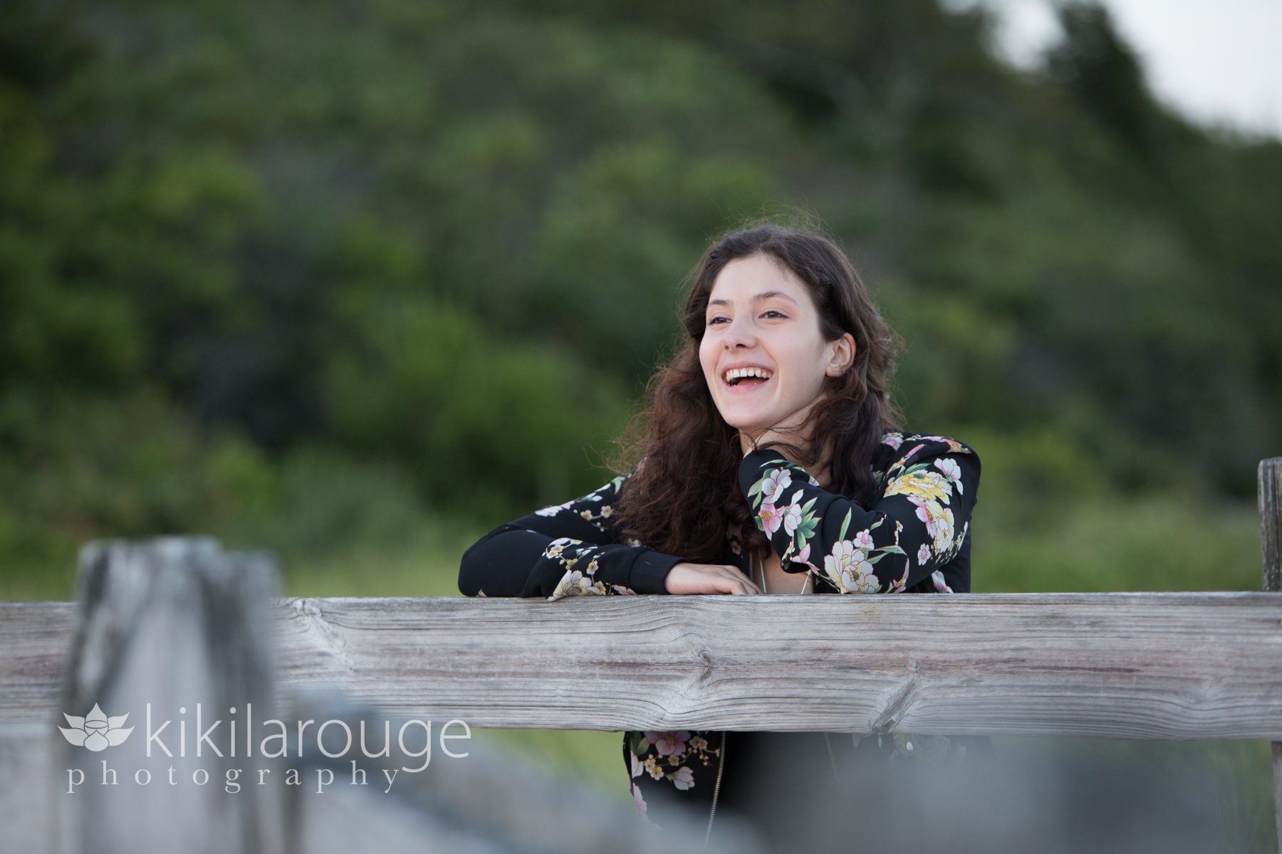 Senior portrait girl laughing on boardwalk