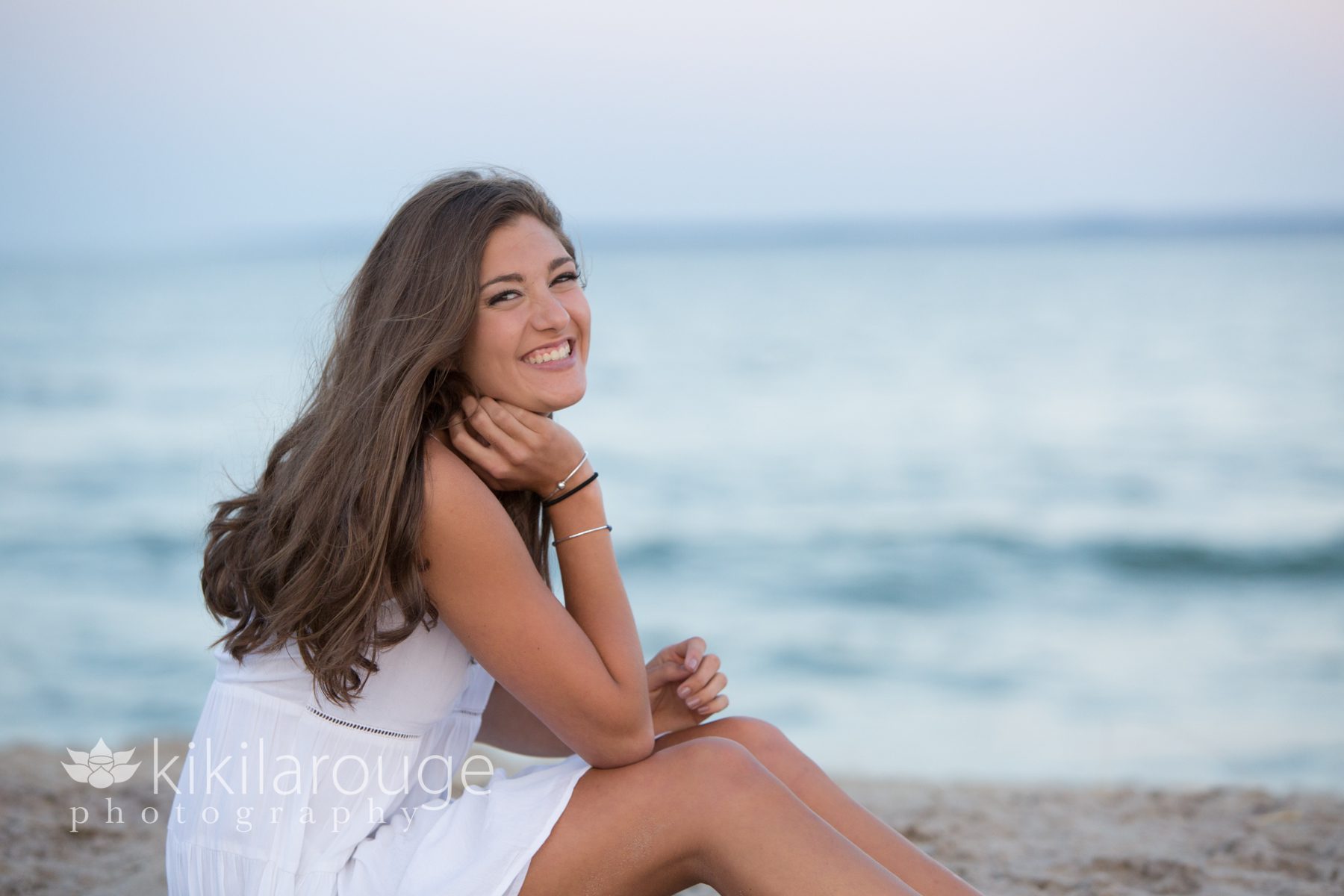 Girl in white dress sunset at beach