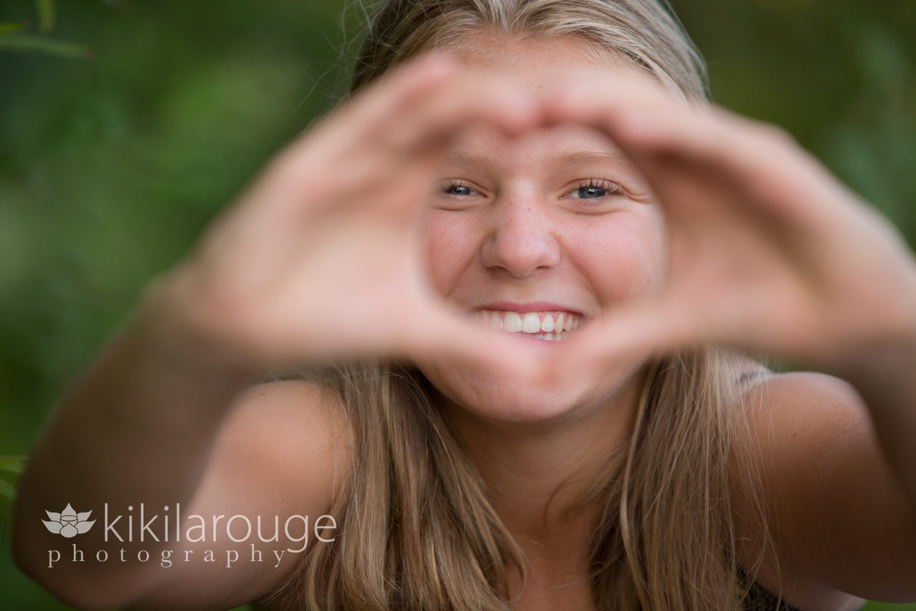 Girl making a heart sign with her hands