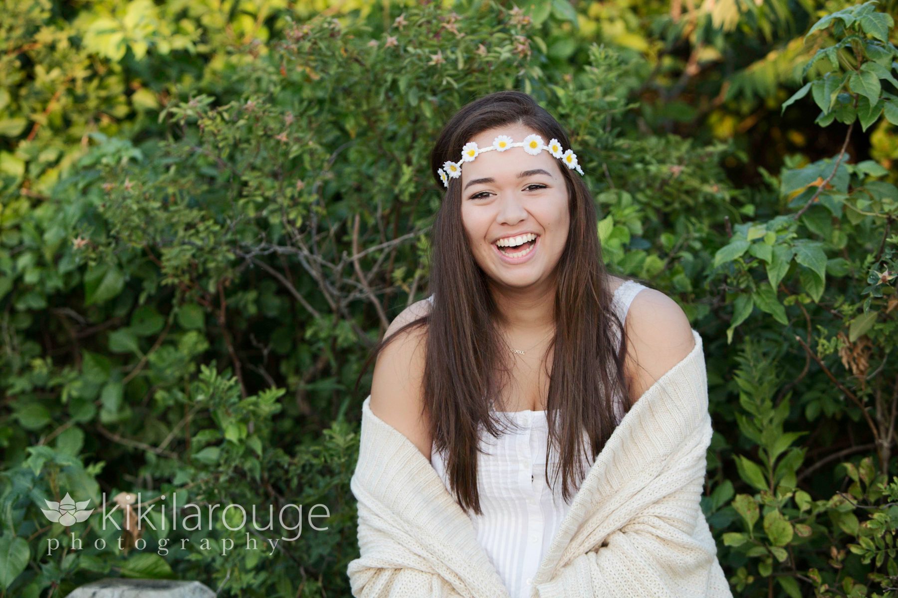 Senior girl laughing with flower garland