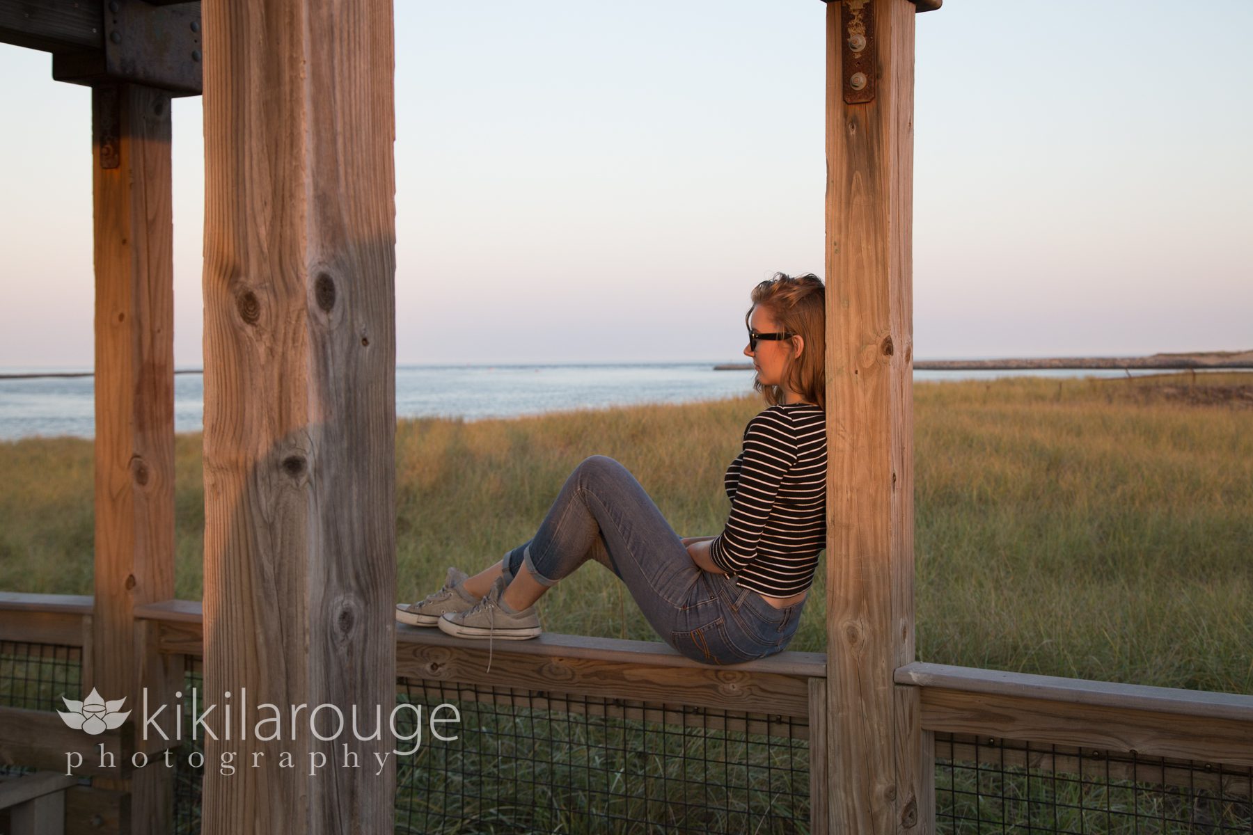 Girl sitting in beach archway