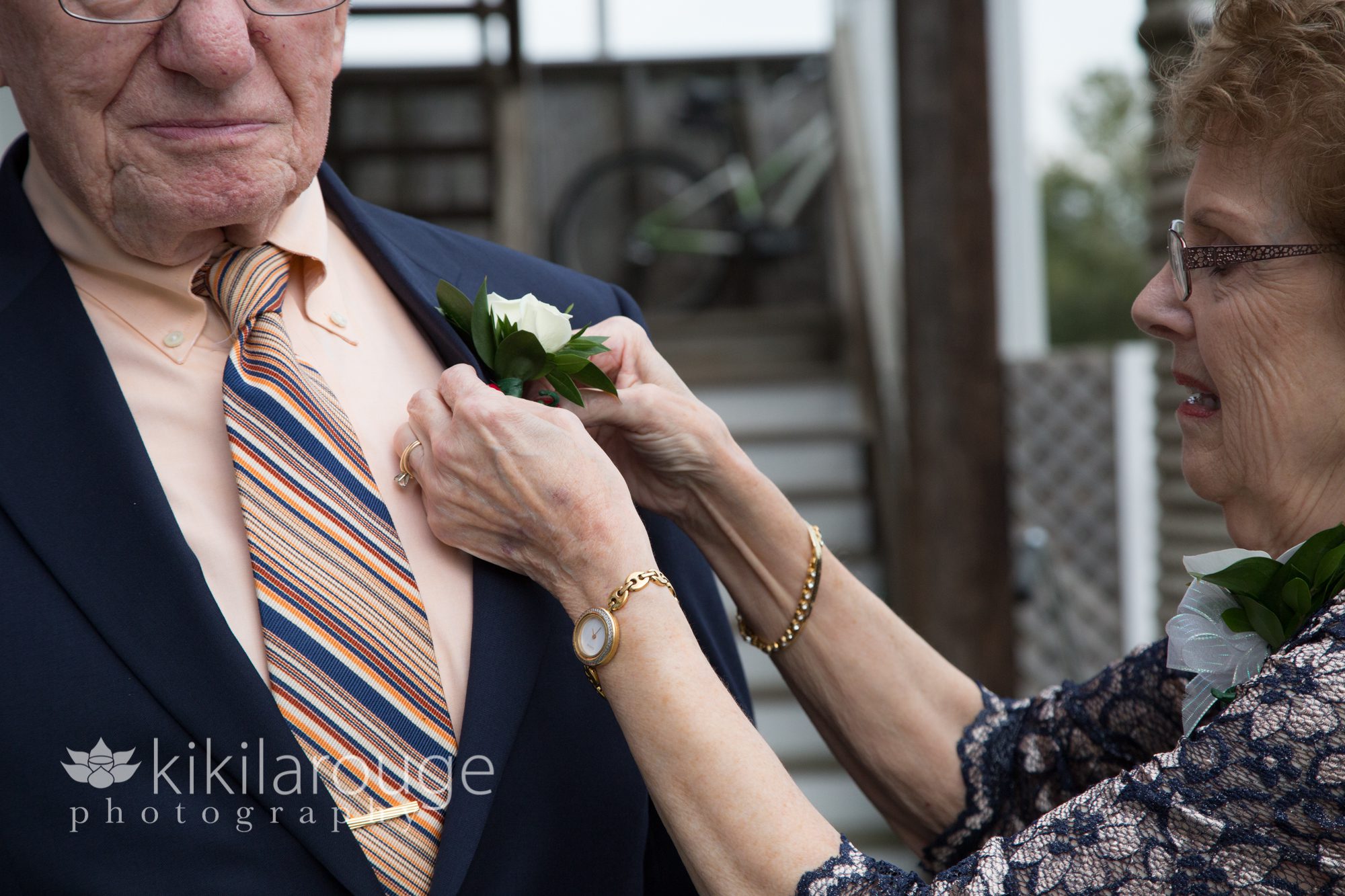 Grandma putting flower on husband at wedding