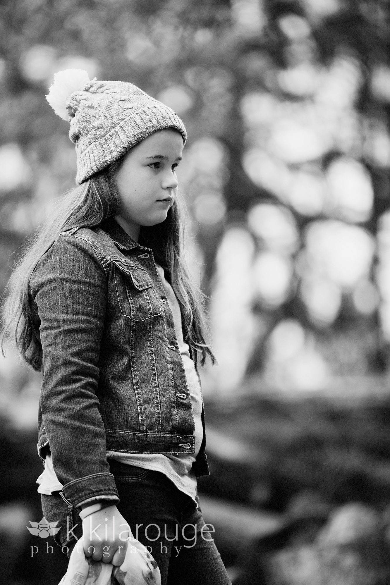 Young girl looking pensive in woods