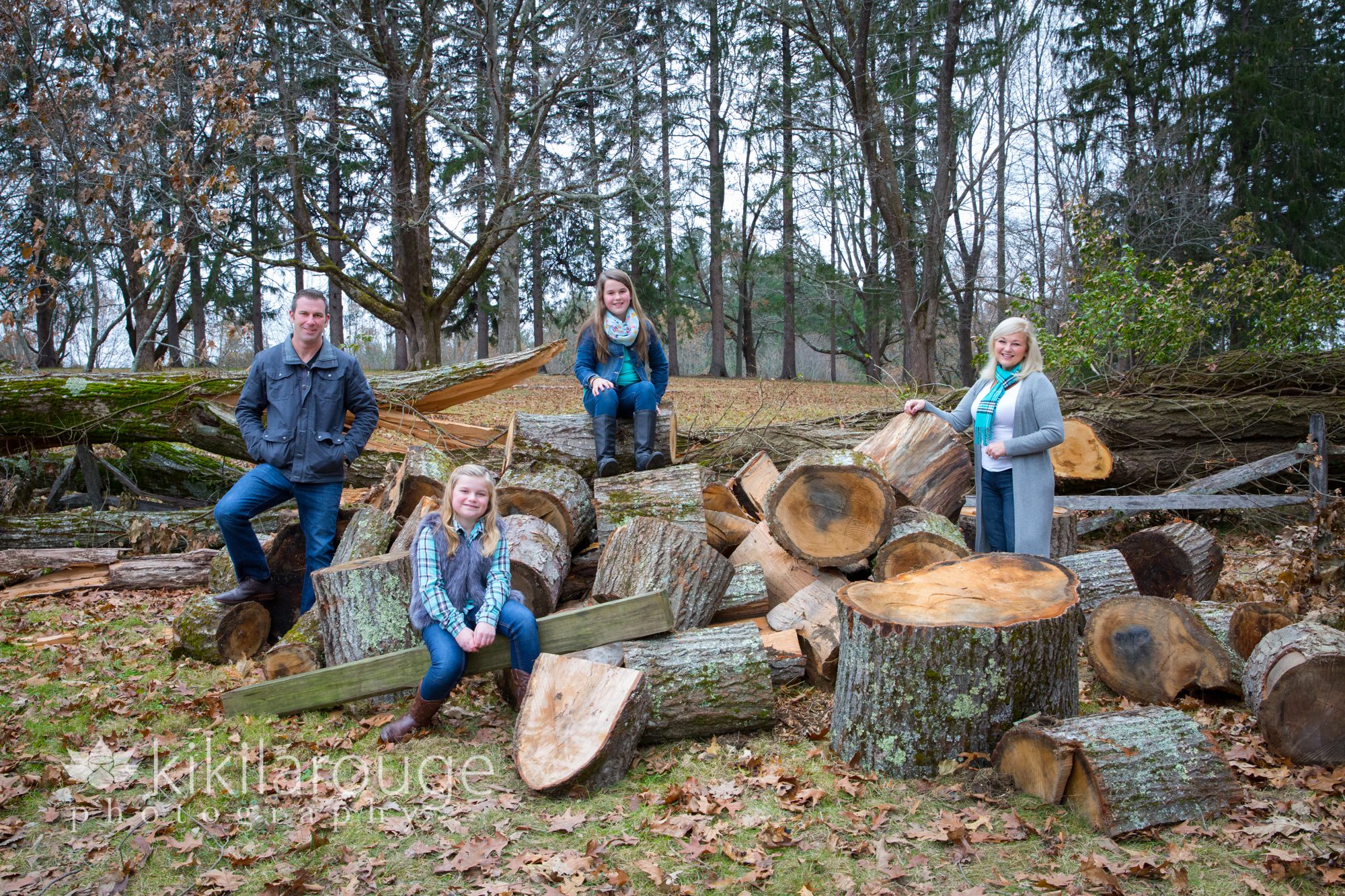 Family portrait on logs in woods
