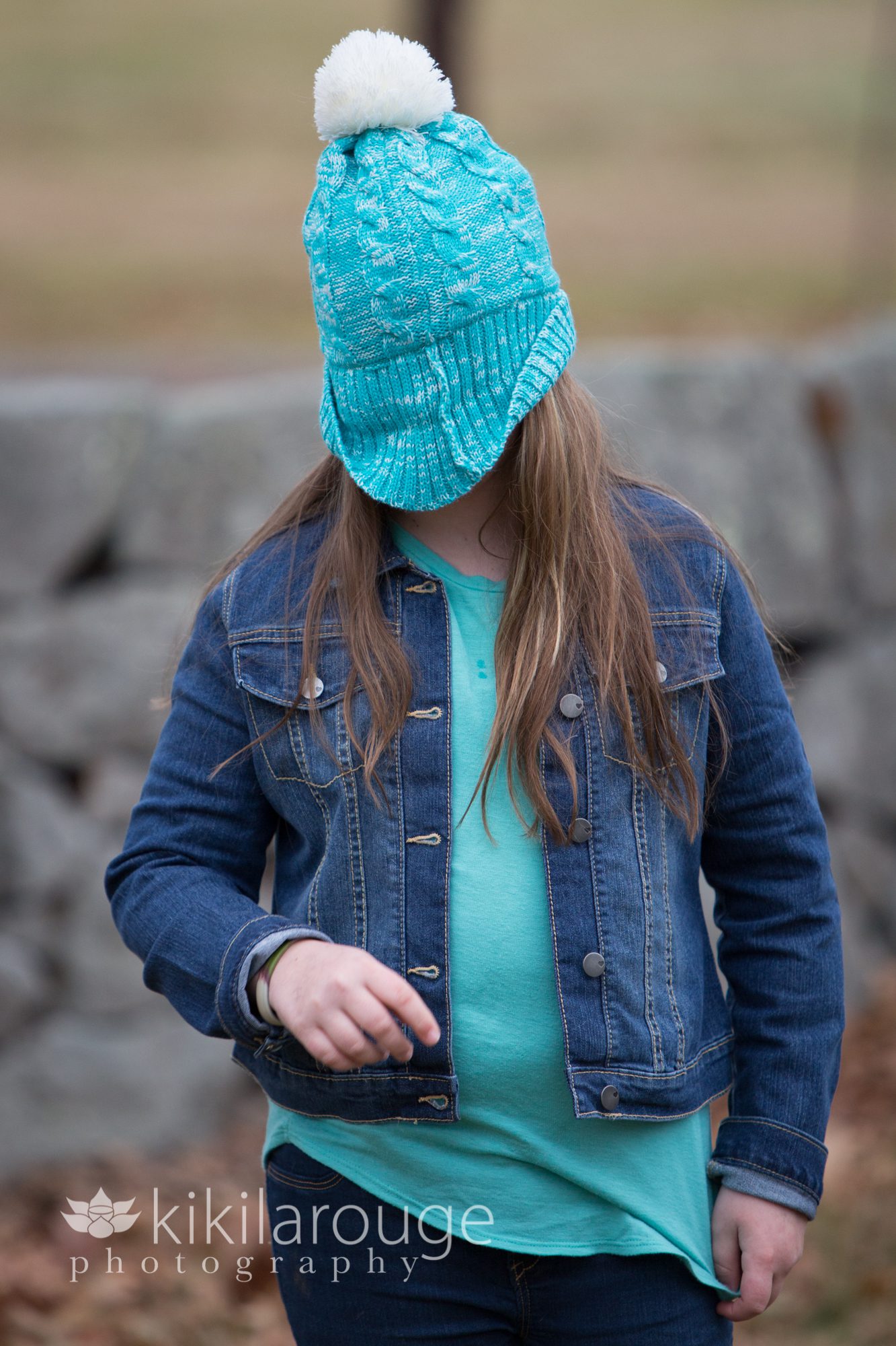 Girl with winter hat pulled over face