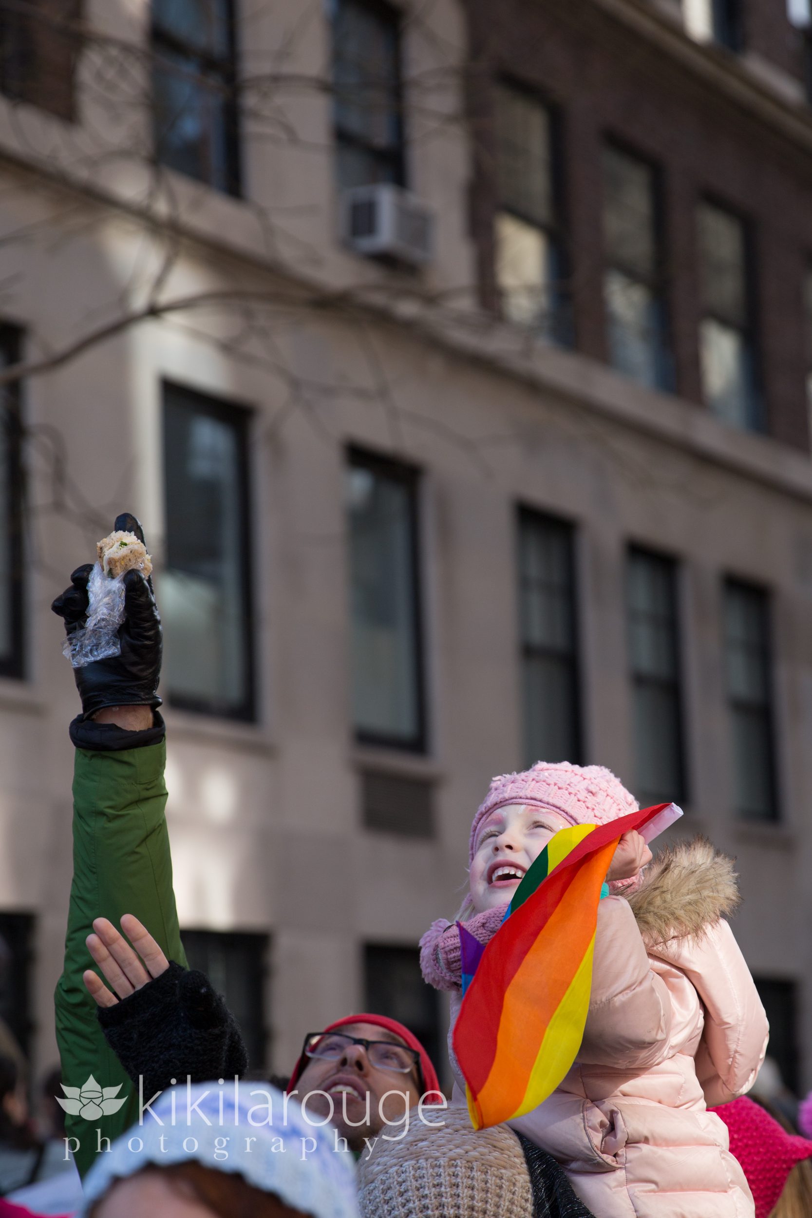 Little girl waving LGBT rainbow flag