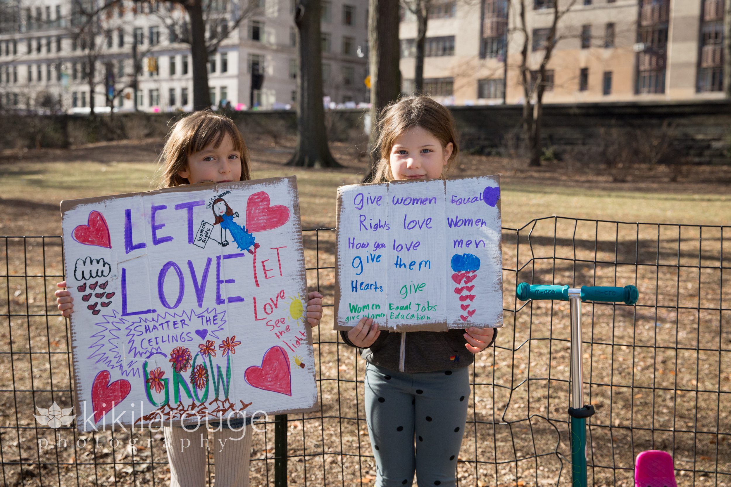 Two young girls with signs at Women's March NYC