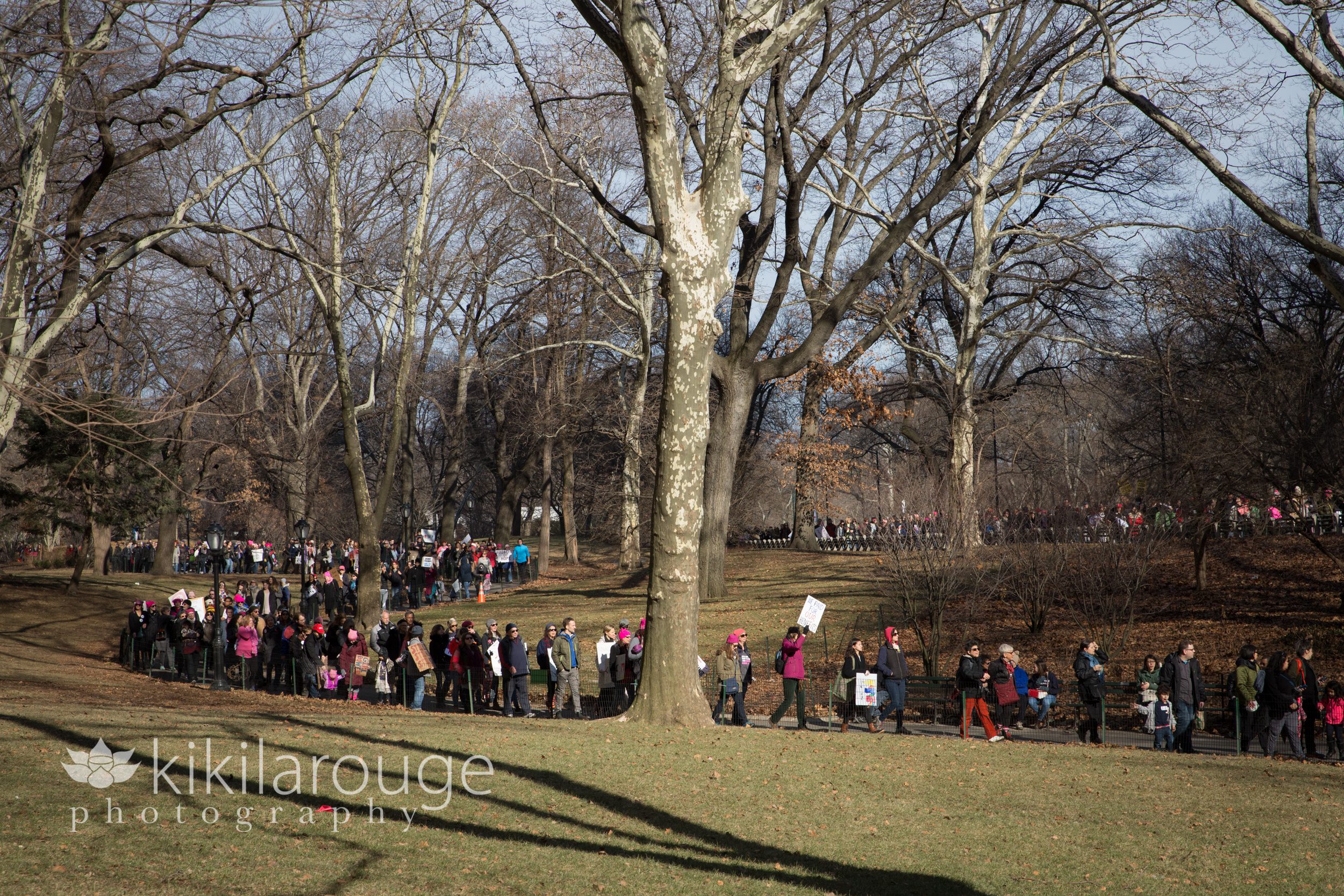 Crowds of people protesting through Central Park