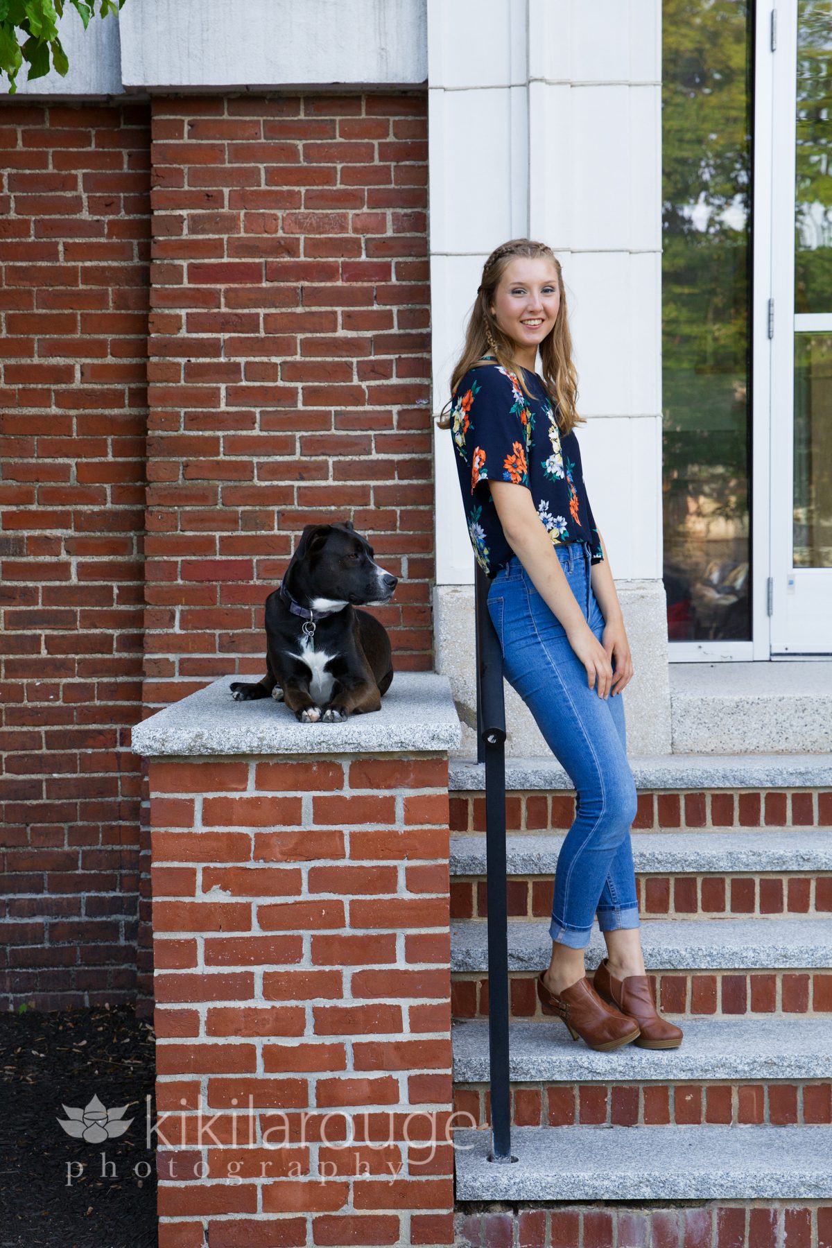 Girl on apt steps in jeans with dog