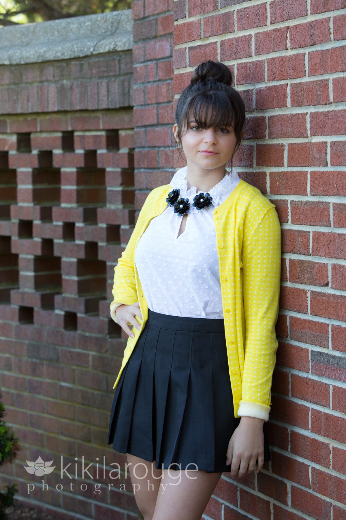 Senior with modeling preppy look in yellow sweater