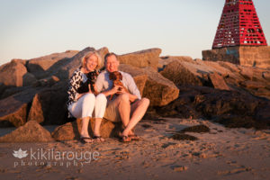 Couple with their two dachshund dogs at beach