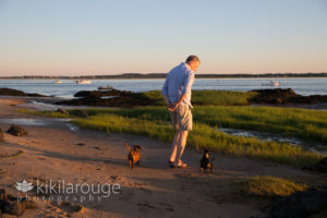 Couple with their two dachshund dogs at beach