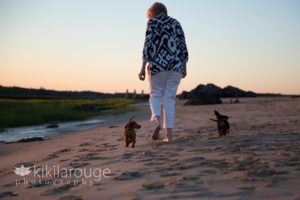 Couple with their two dachshund dogs at beach