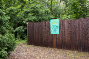 Sign about walking shelter dogs next to the woods