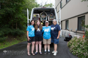 Dog rescue team in front of transport van