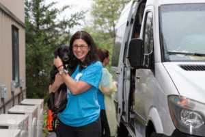 Girl walking through shelter door with rescue puppy