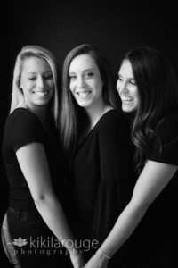 Portrait of three sisters all dresses in black