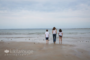 Mom with kids walking towards waters edge at Plum Island Beach