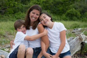 Mom with son and daughter on driftwood Plum Island