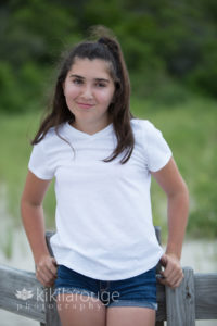 Young girl smirking on Sandy Point boardwalk beach