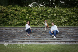 Family sitting on granite steps in arboretum
