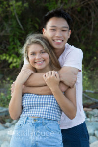 Brother and sister hugging at beach