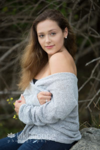 Girl with gray sweater off the shoulder