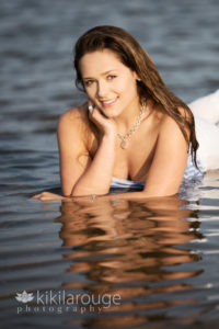 Girl posing in tide pool with white jeans