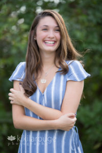 Gril in light blue jumpsuit laughing