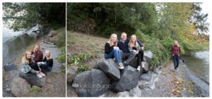 Family sitting on rocks at water's edge Seattle