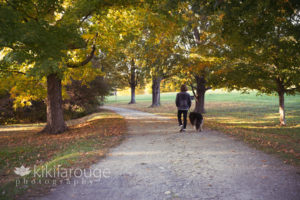 Boy walking fall path with dog